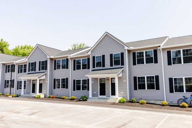 Manchester residential townhome community with attached drive-under garage and designated parking